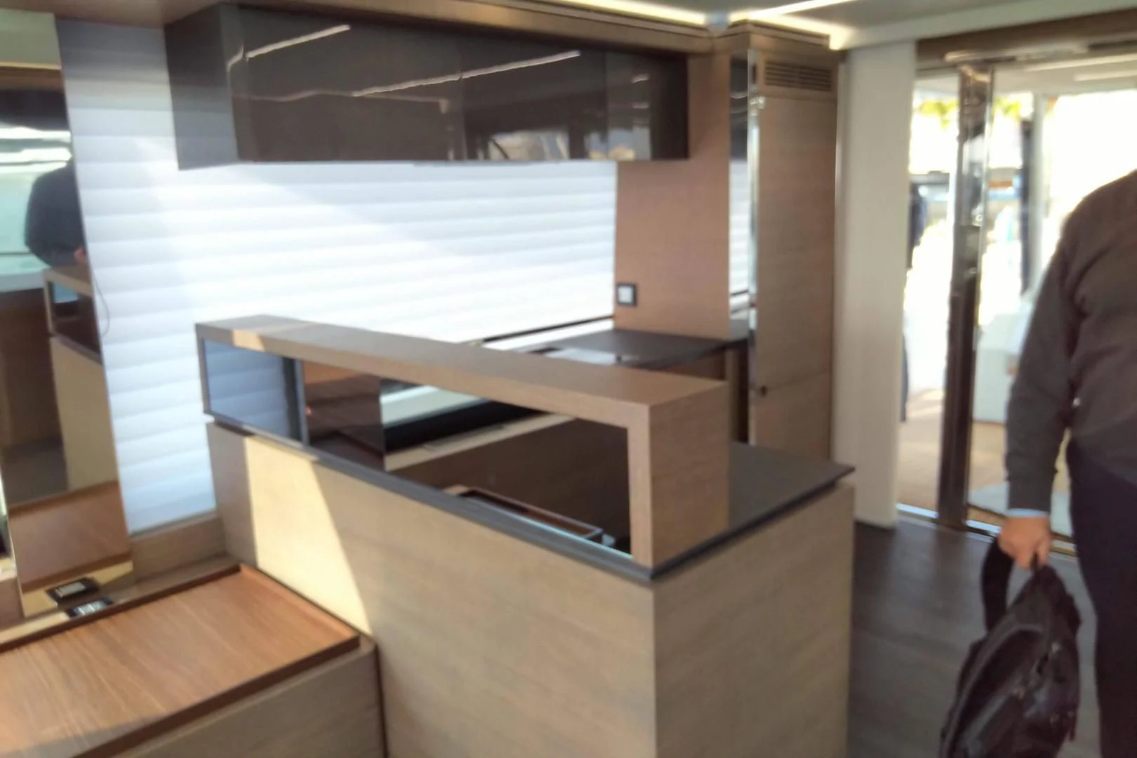 a person standing next to a large display case aboard SERENITY Yacht for Sale
