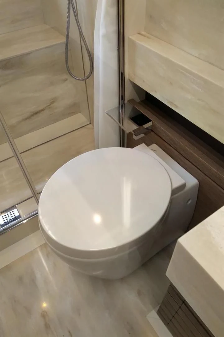 a toilet in a bathroom aboard SERENITY Yacht for Sale