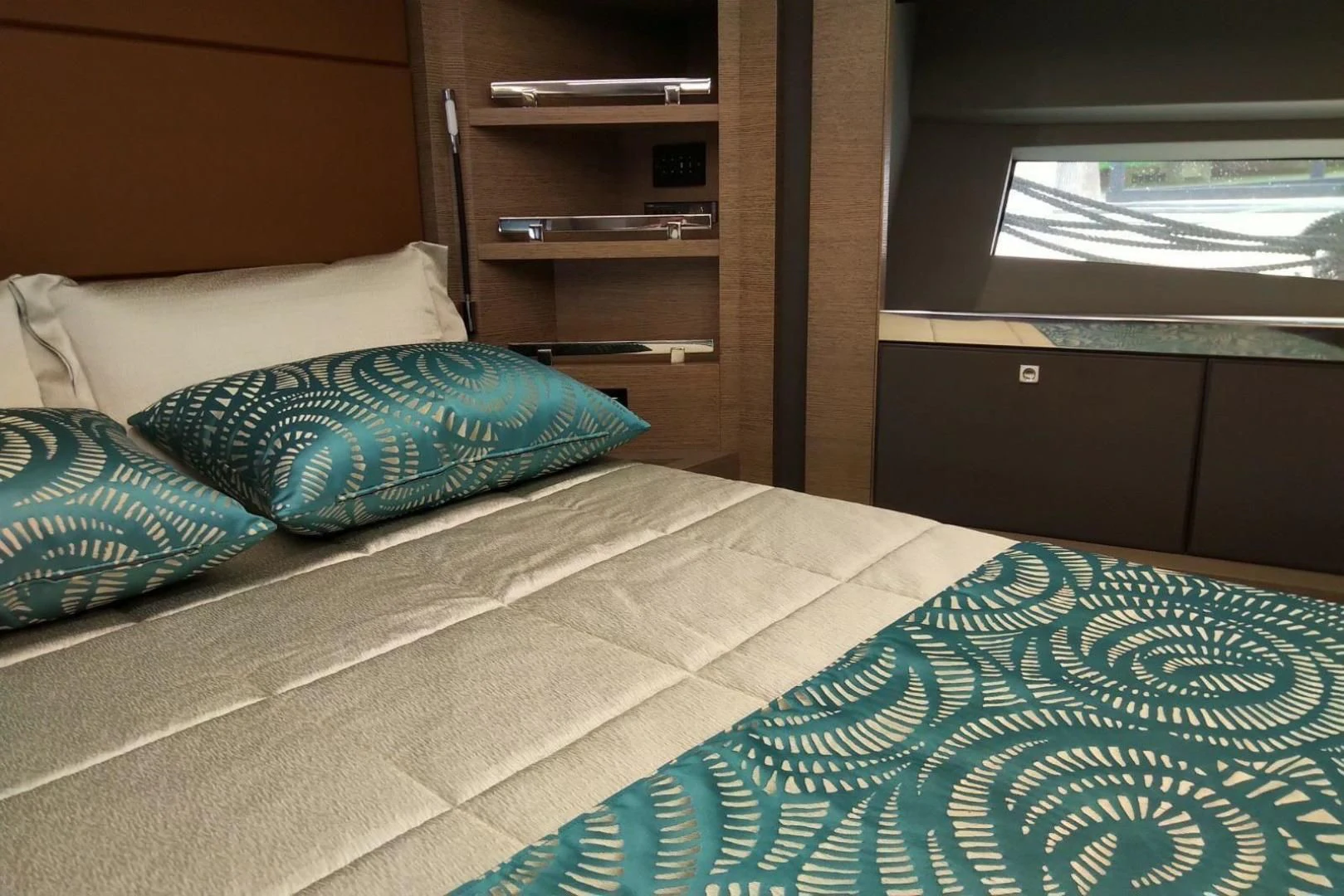 a bed with blue and white sheets aboard SERENITY Yacht for Sale