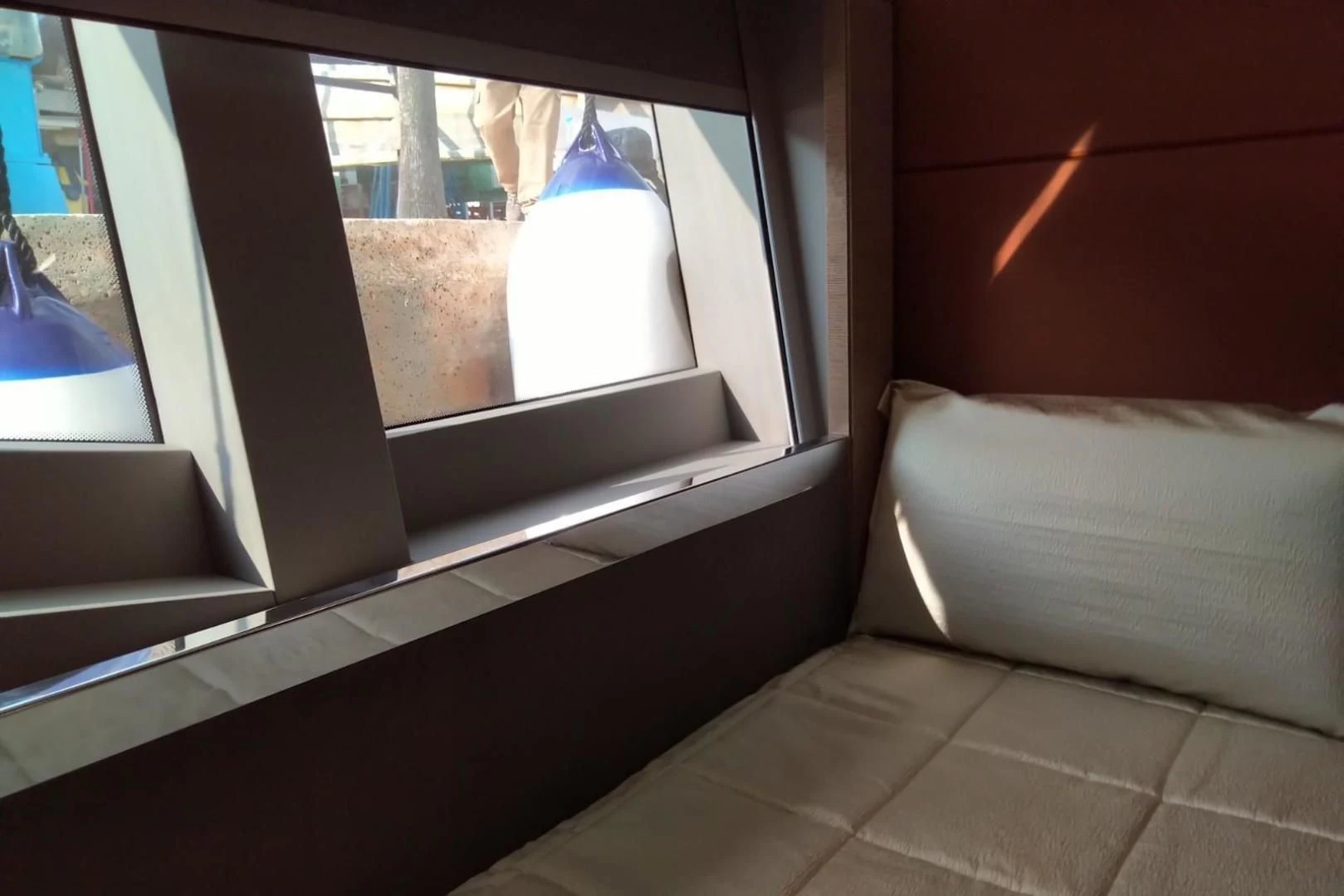 a bed next to a window aboard SERENITY Yacht for Sale