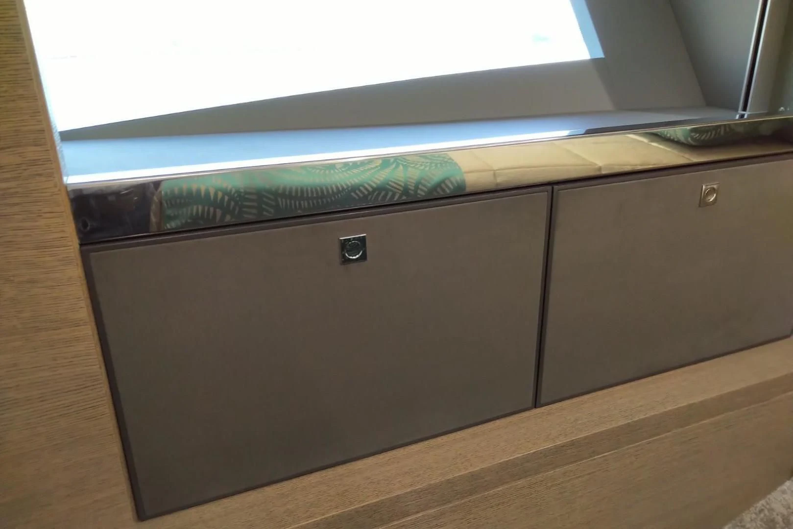 a wooden cabinet with a green and blue cloth on it aboard SERENITY Yacht for Sale