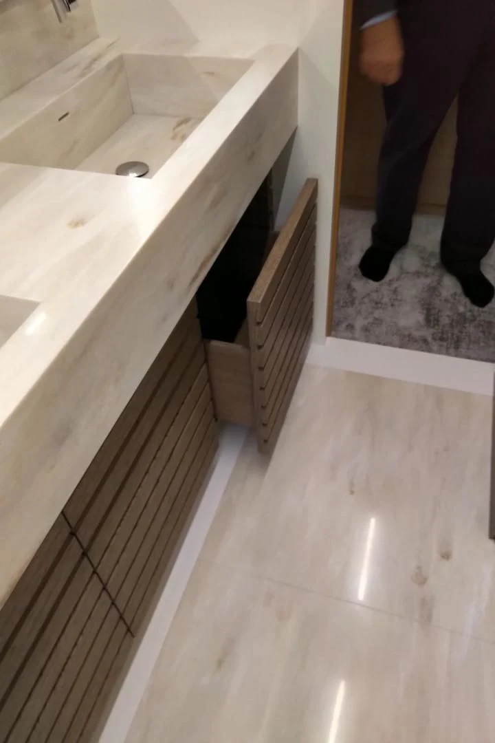 a person standing next to a sink aboard SERENITY Yacht for Sale