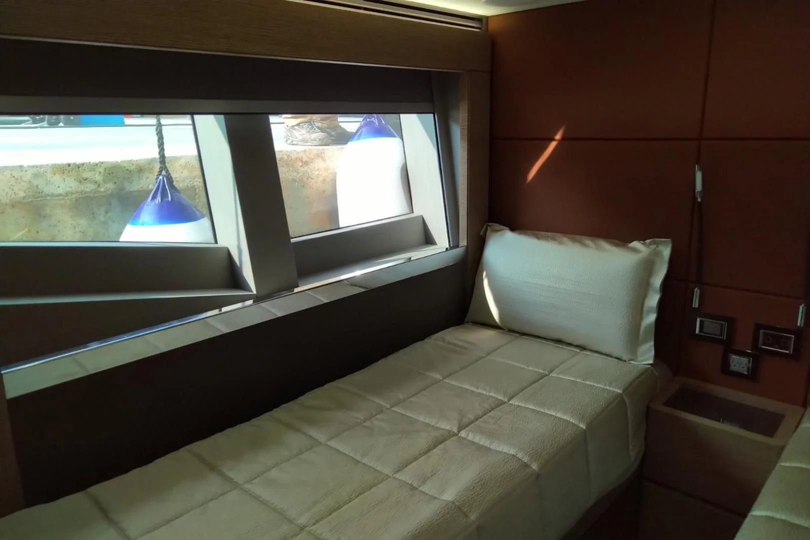 a bed with a window aboard SERENITY Yacht for Sale