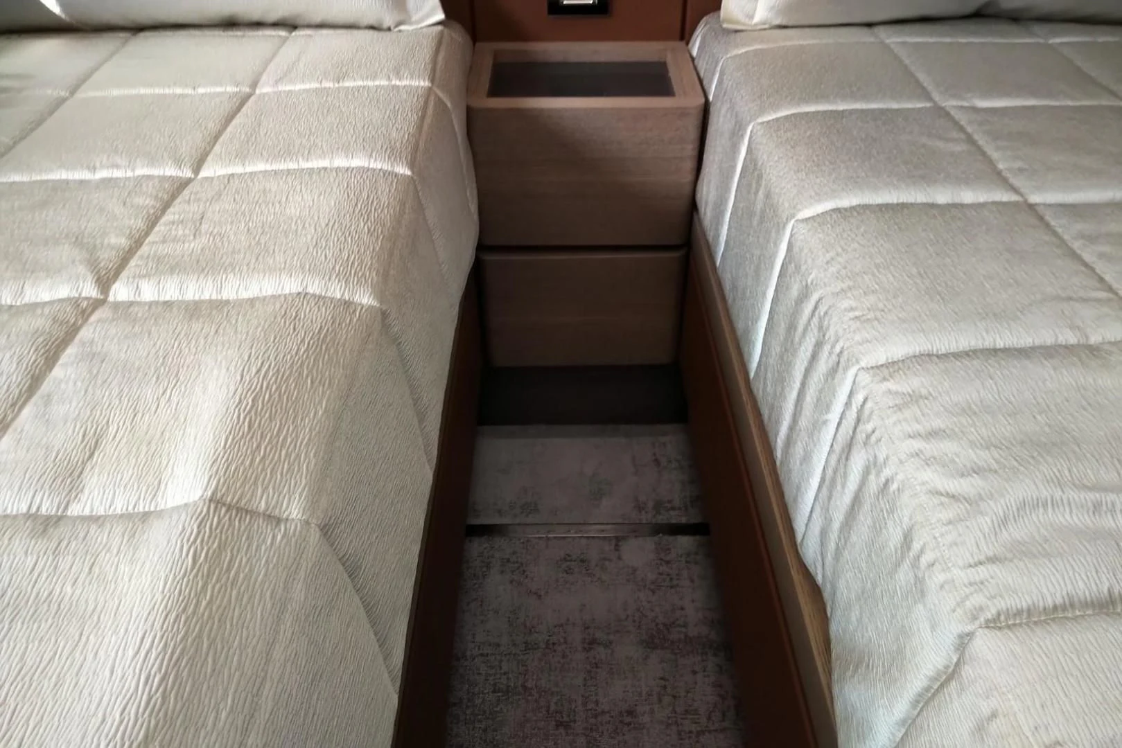 a bed with white sheets aboard SERENITY Yacht for Sale