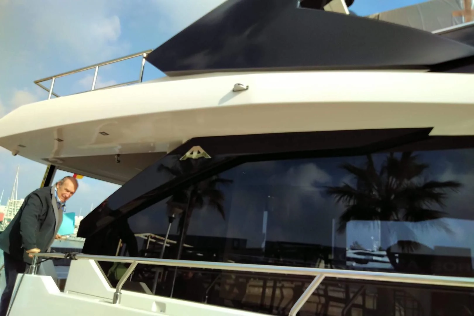 a person standing next to a white boat aboard SERENITY Yacht for Sale