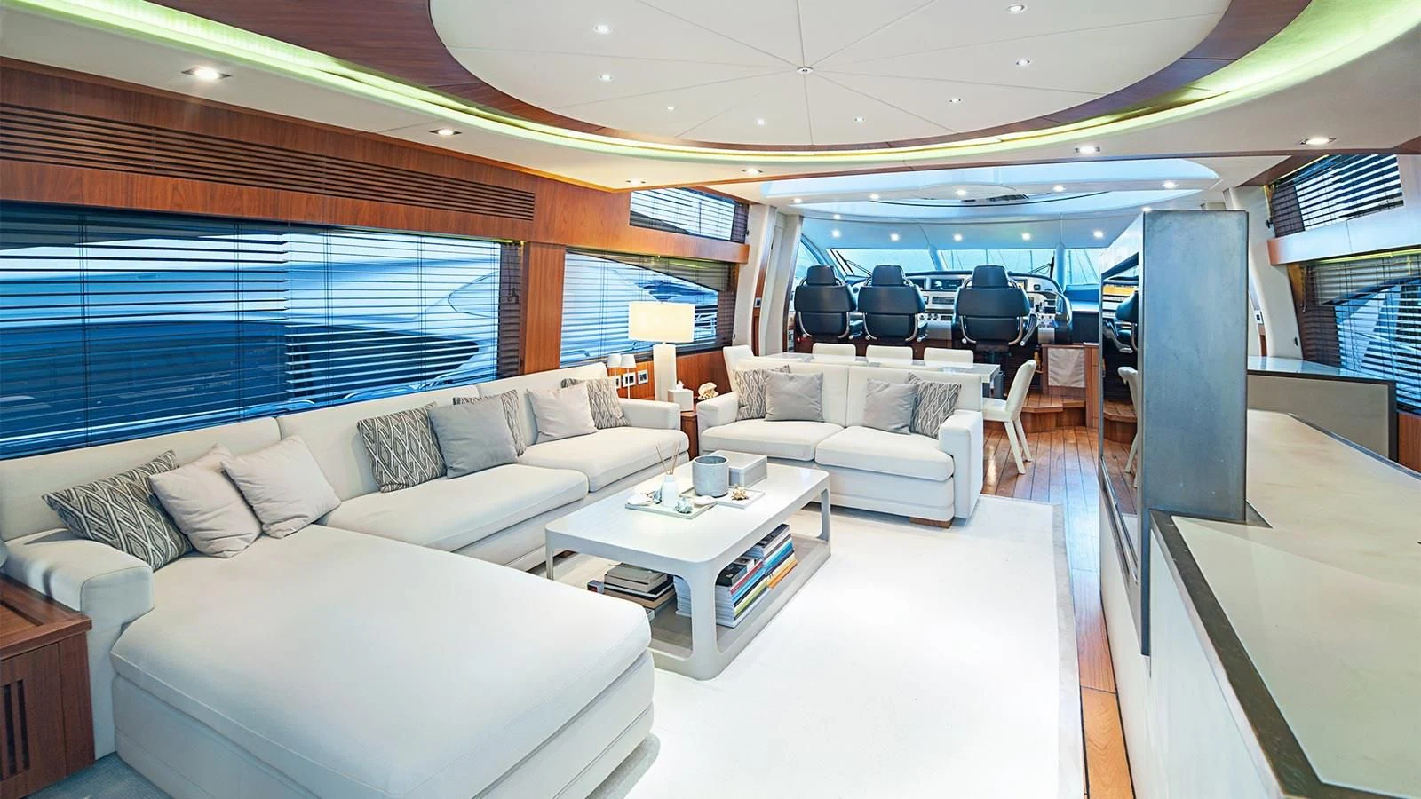 a living room with a large window aboard BLADE 6 Yacht for Charter
