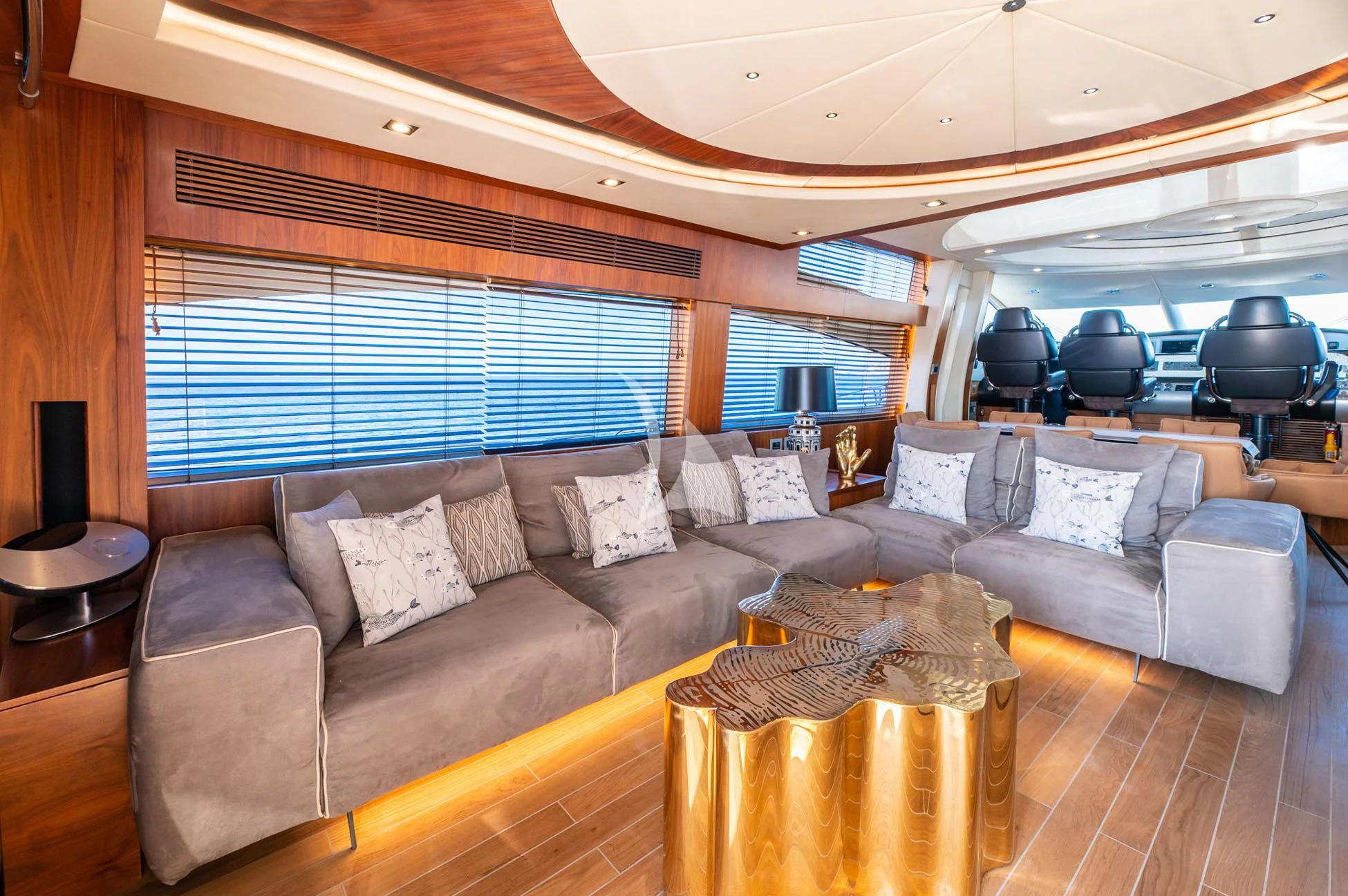 a living room with a large sofa aboard BLADE 6 Yacht for Charter