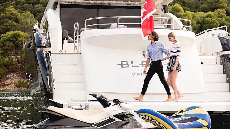 a man and woman walking on a boat aboard BLADE 6 Yacht for Charter