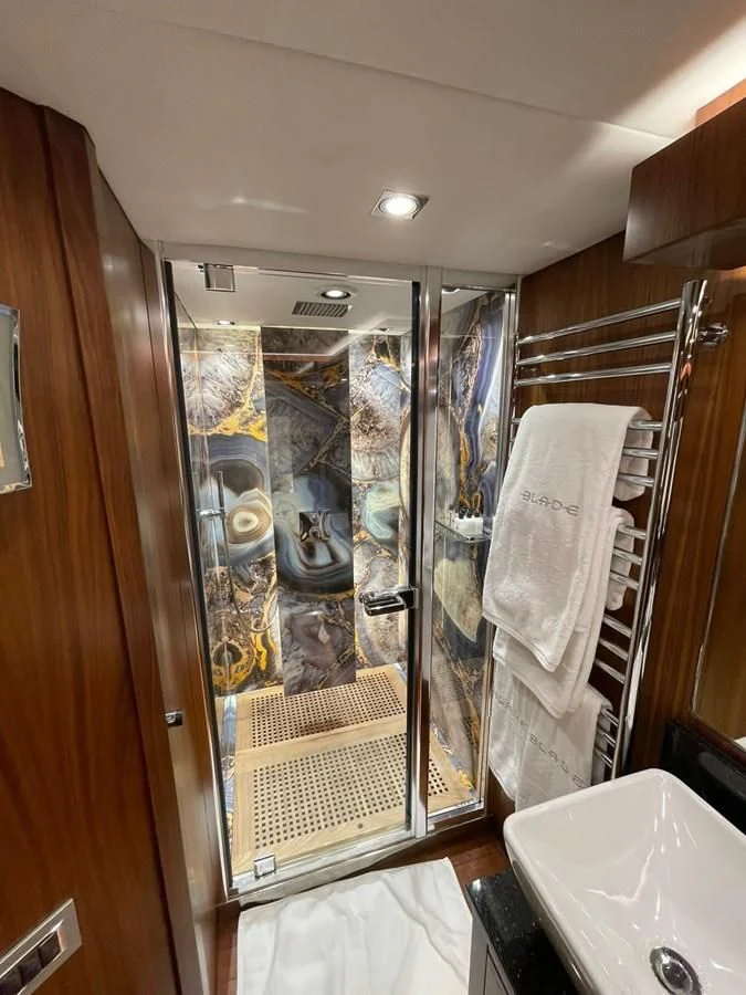 a bathroom with a glass shower aboard BLADE 6 Yacht for Charter