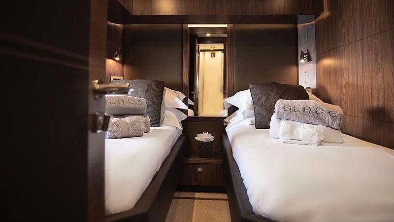 a room with two beds aboard BLADE 6 Yacht for Charter