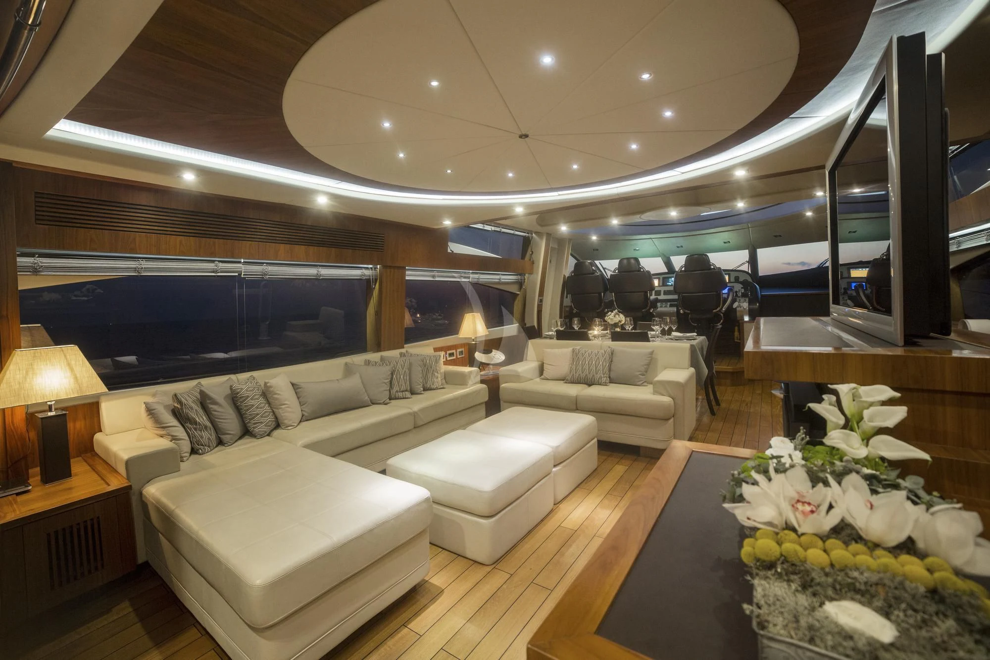 a living room with a large window aboard BLADE 6 Yacht for Charter