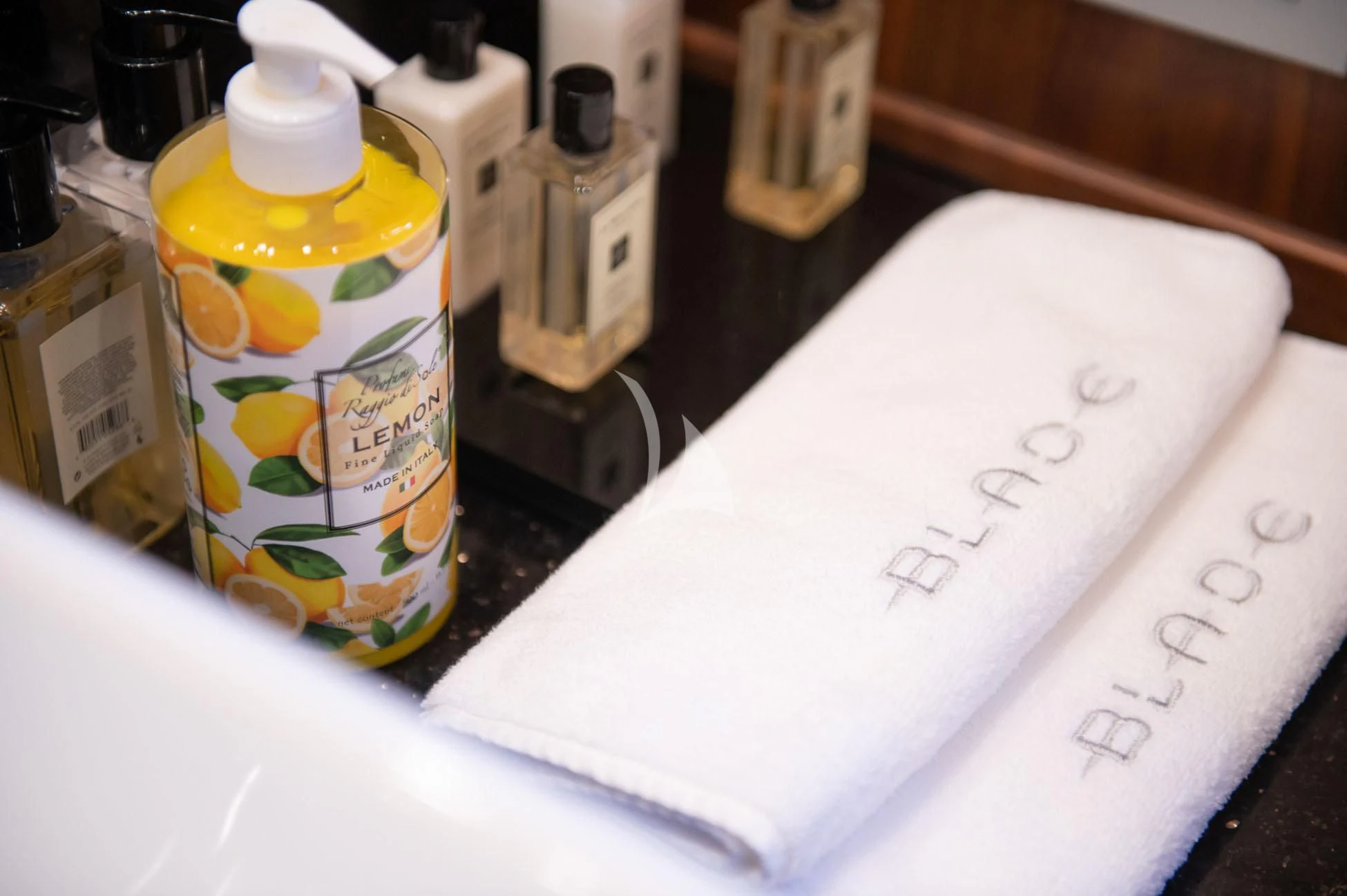 a white piece of paper with writing on it next to a bottle of oil aboard BLADE 6 Yacht for Charter