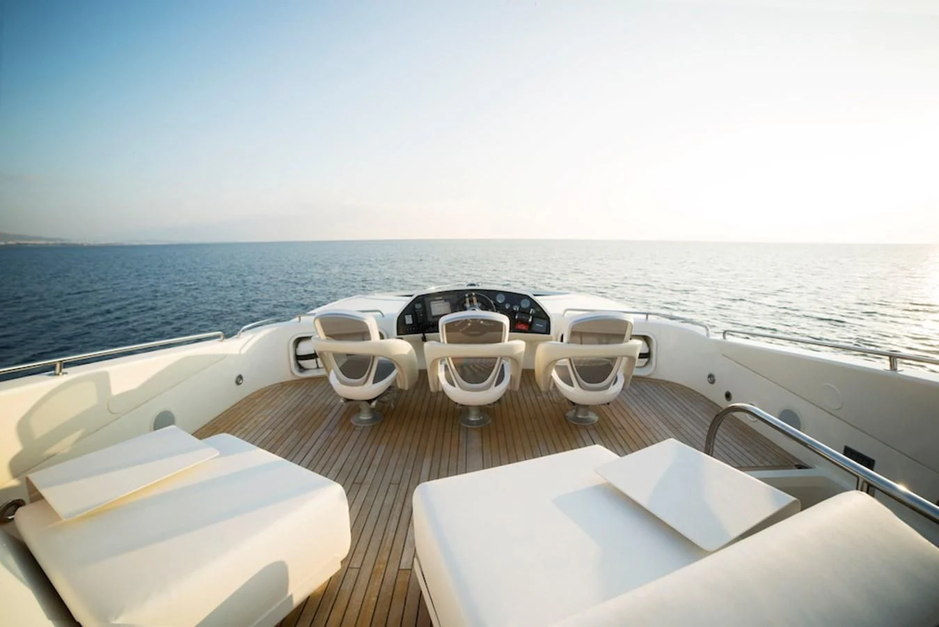 a table with chairs on it next to a body of water aboard BLADE 6 Yacht for Charter