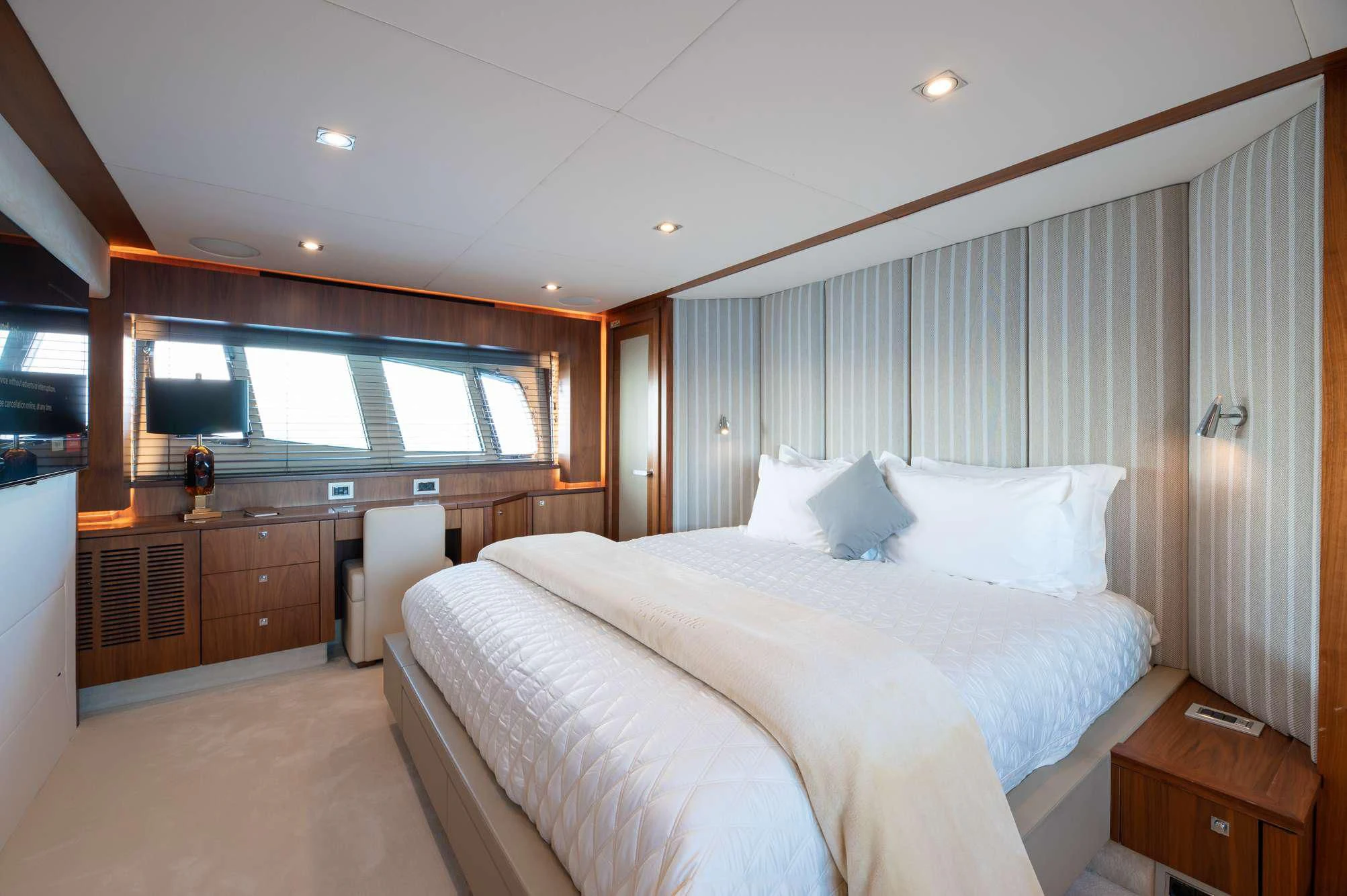 a bedroom with a large bed aboard BLADE 6 Yacht for Charter