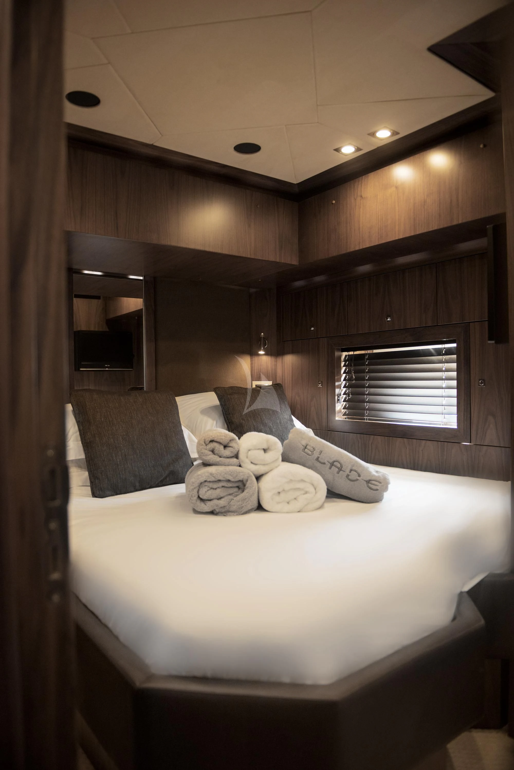 a bed with pillows and pillows aboard BLADE 6 Yacht for Charter