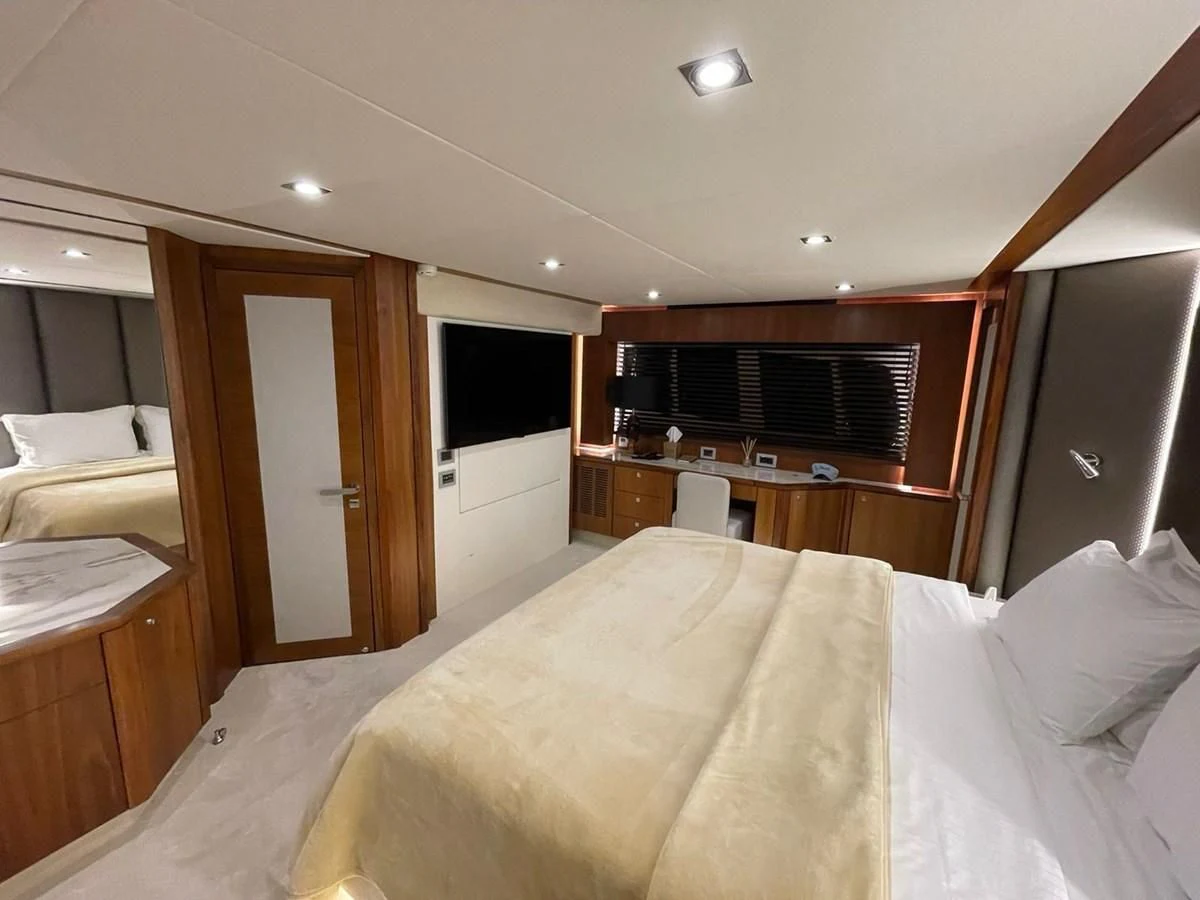 a bedroom with a bed and a microwave aboard BLADE 6 Yacht for Charter