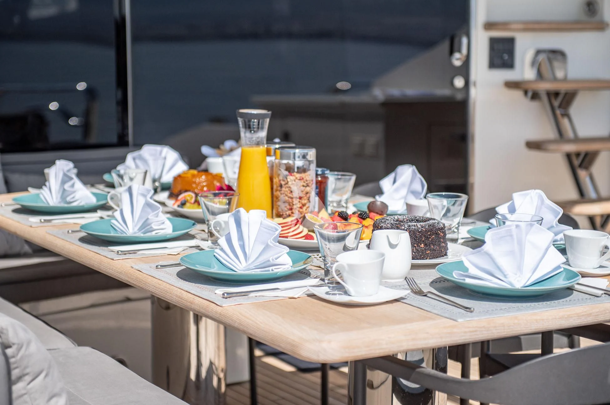 a table with plates and cups on it aboard BLADE 6 Yacht for Charter