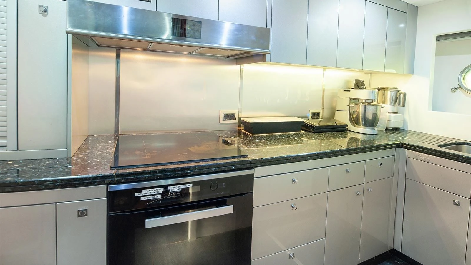 a kitchen with white cabinets aboard BLADE 6 Yacht for Charter