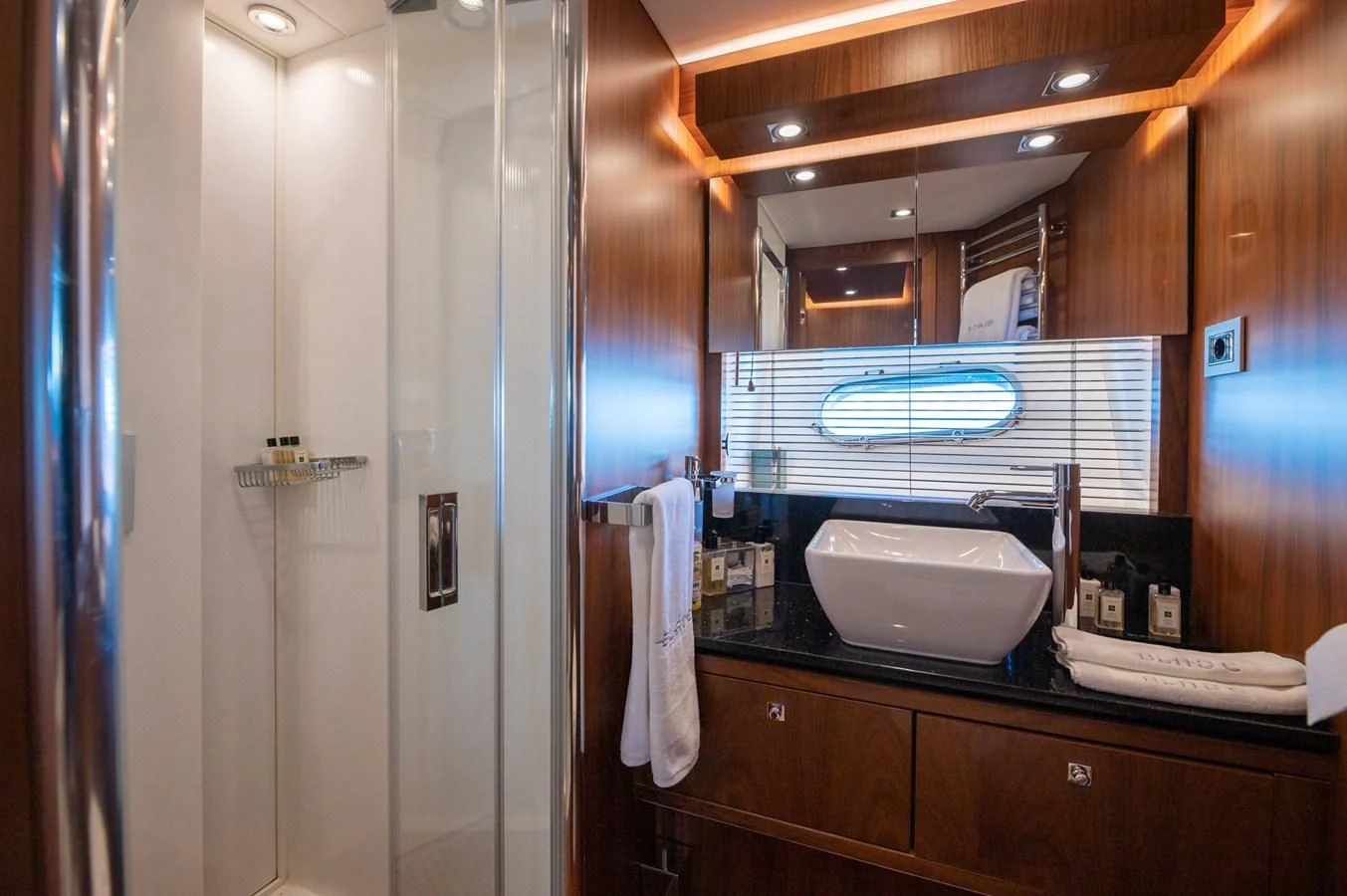 a bathroom with a large mirror aboard BLADE 6 Yacht for Charter