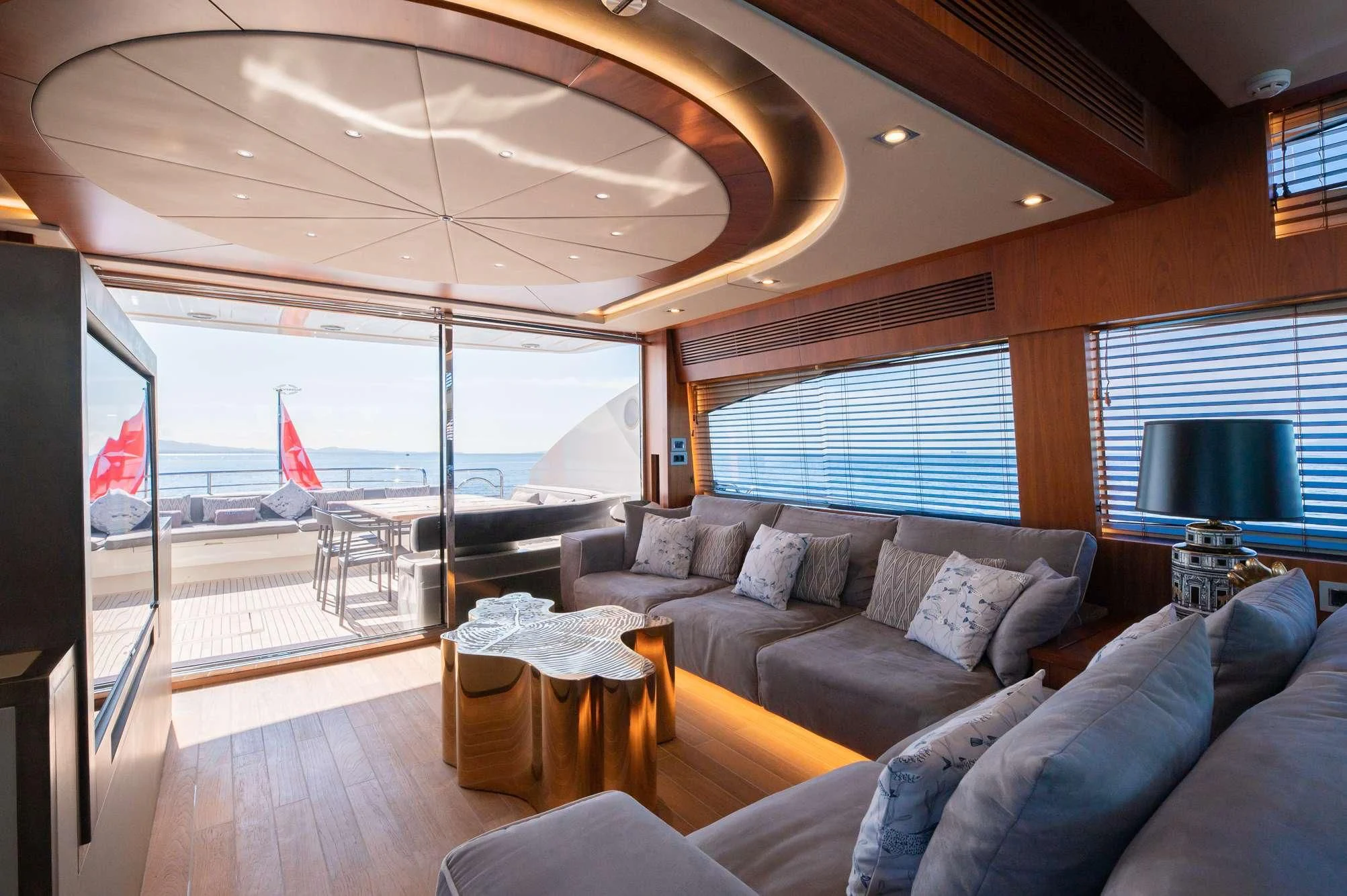 a living room with a large glass window aboard BLADE 6 Yacht for Charter