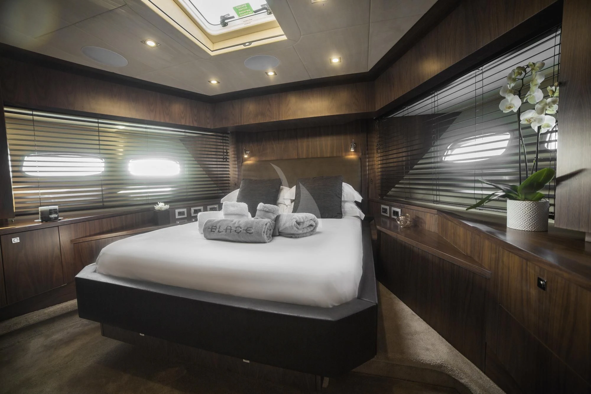 a room with a bed and a plant aboard BLADE 6 Yacht for Charter