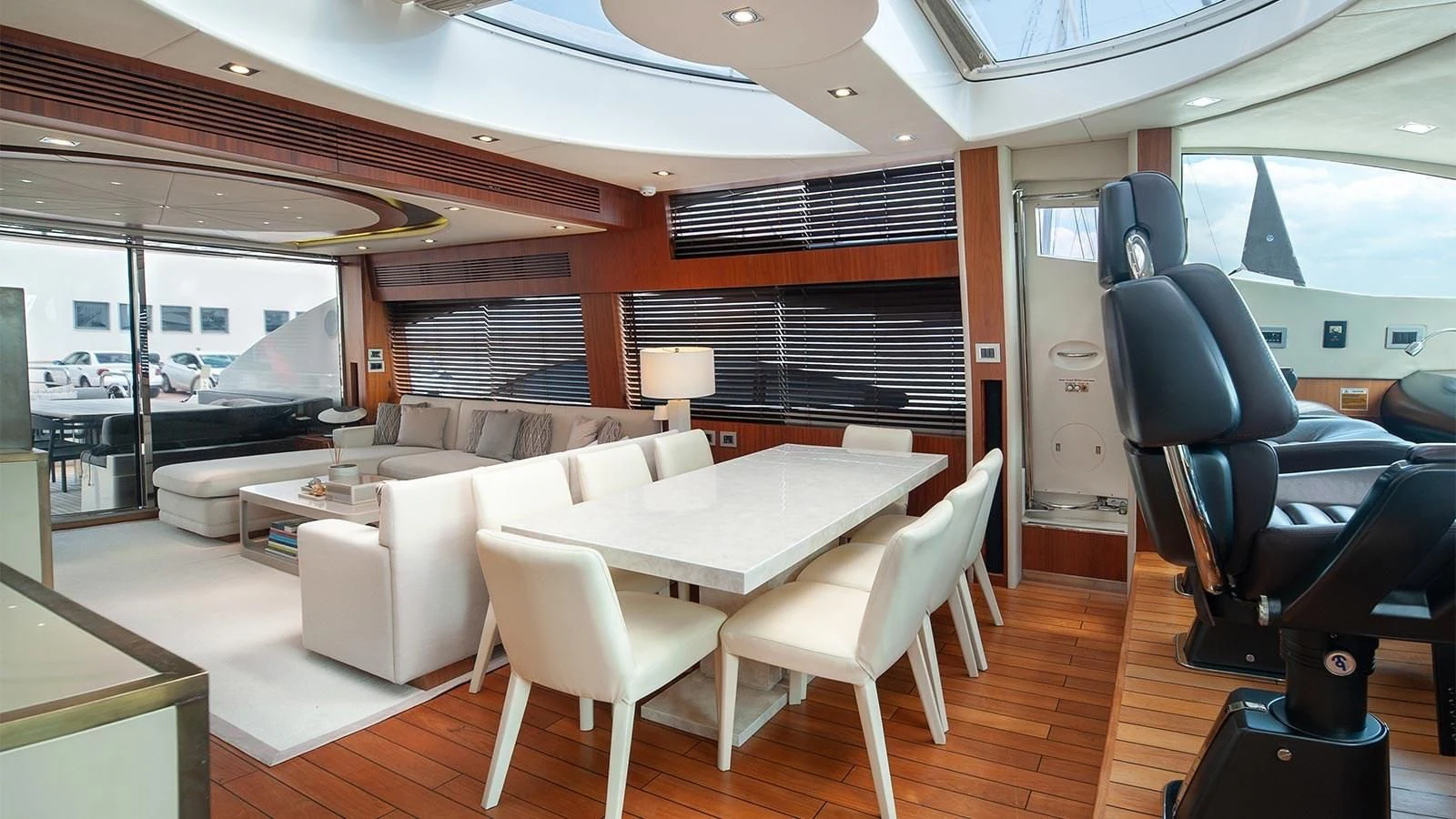 a room with a table chairs and a television aboard BLADE 6 Yacht for Charter