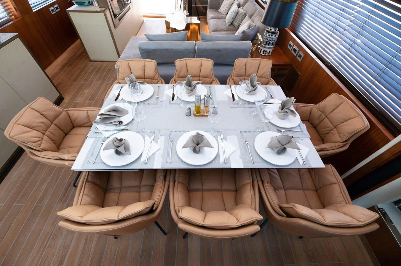 a table set with plates and chairs aboard BLADE 6 Yacht for Charter