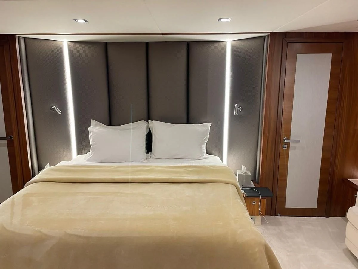 a bed with white sheets aboard BLADE 6 Yacht for Charter