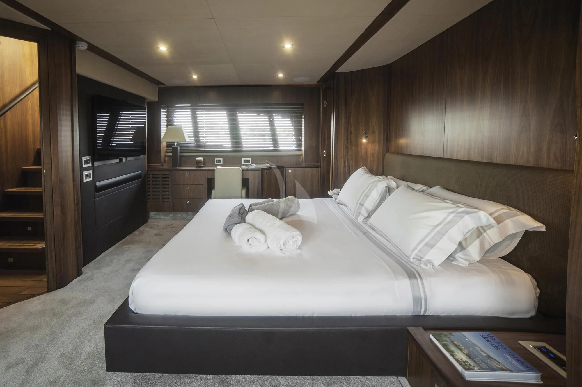 a bed with white sheets aboard BLADE 6 Yacht for Charter