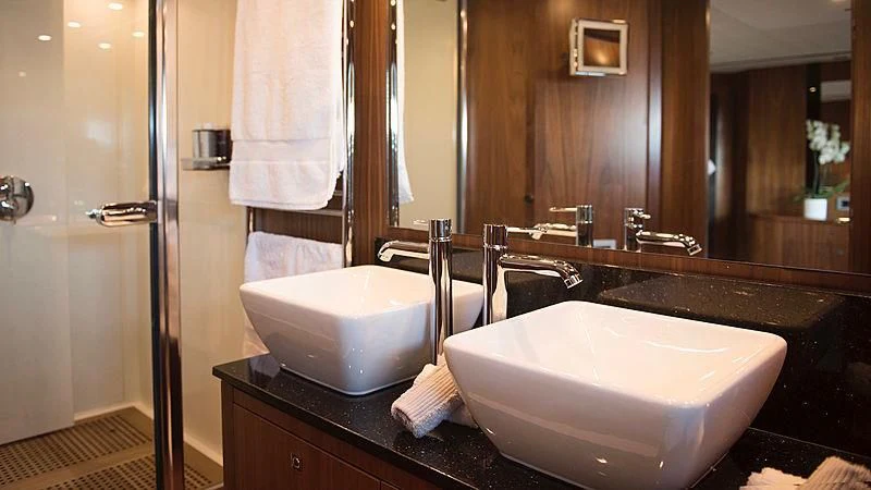 a bathroom with a sink and a large mirror aboard BLADE 6 Yacht for Charter