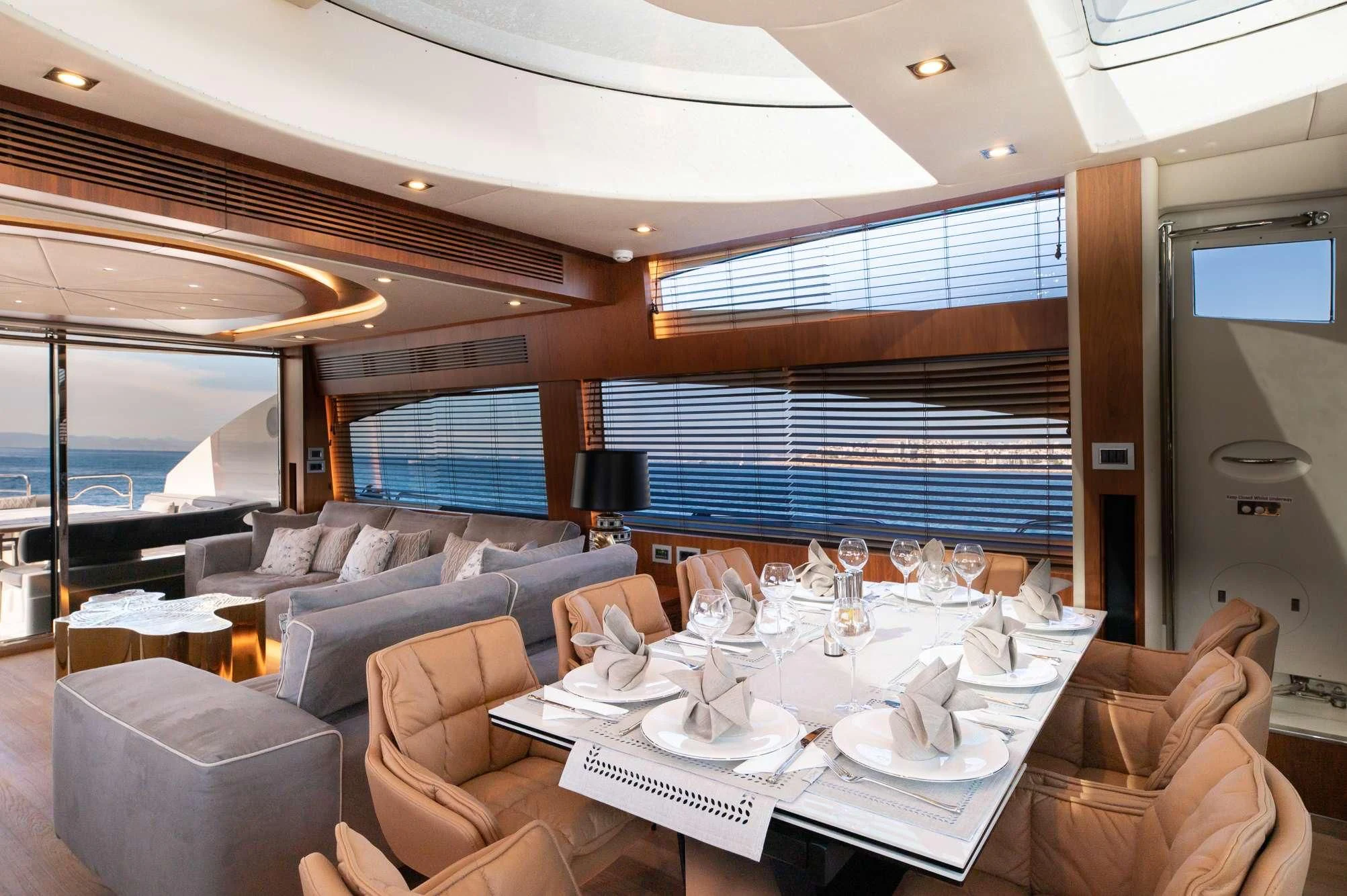 a large room with a table and chairs aboard BLADE 6 Yacht for Charter