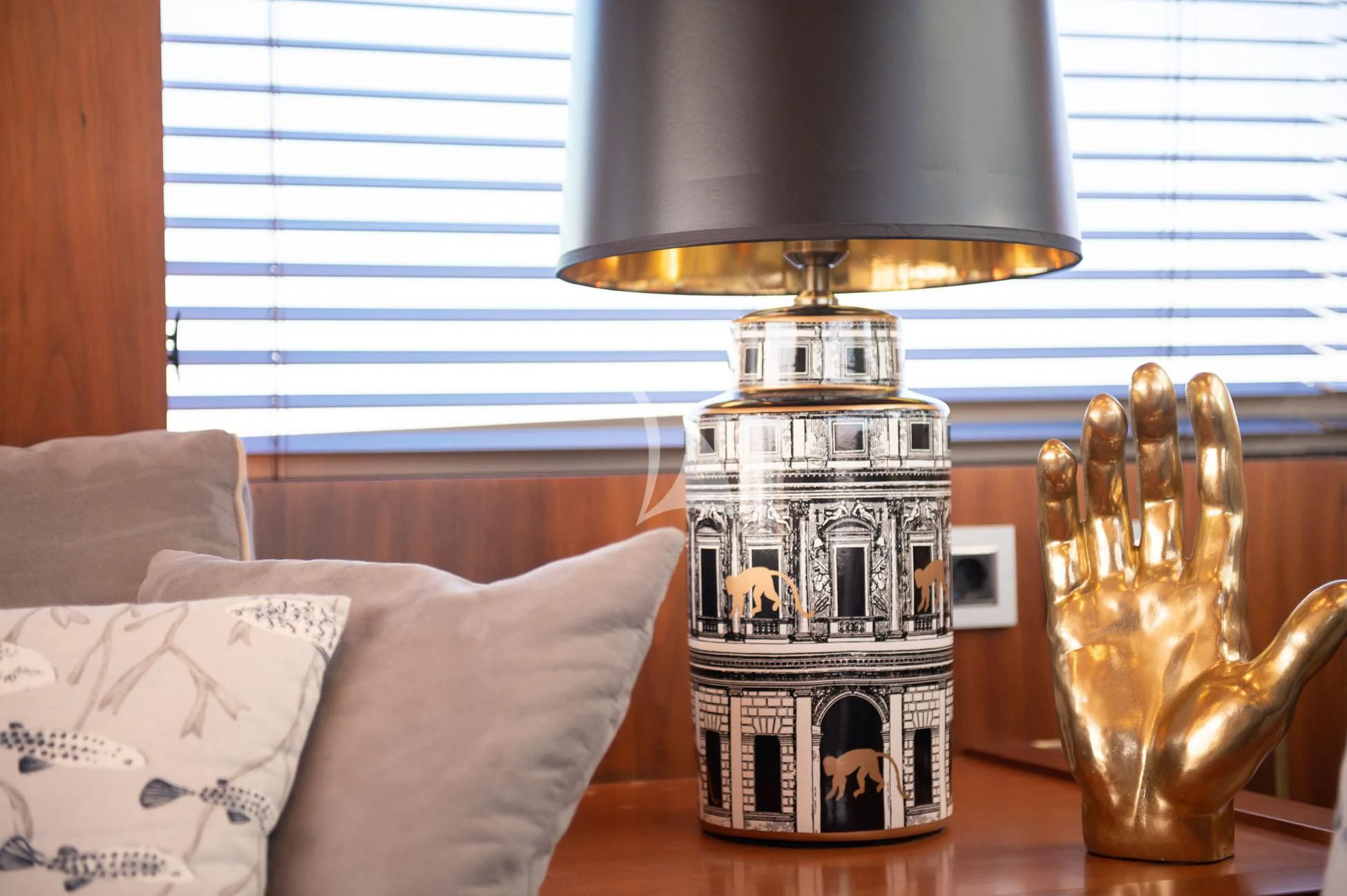 a glass jar with a lid on a table with a lamp and a window in the background aboard BLADE 6 Yacht for Charter