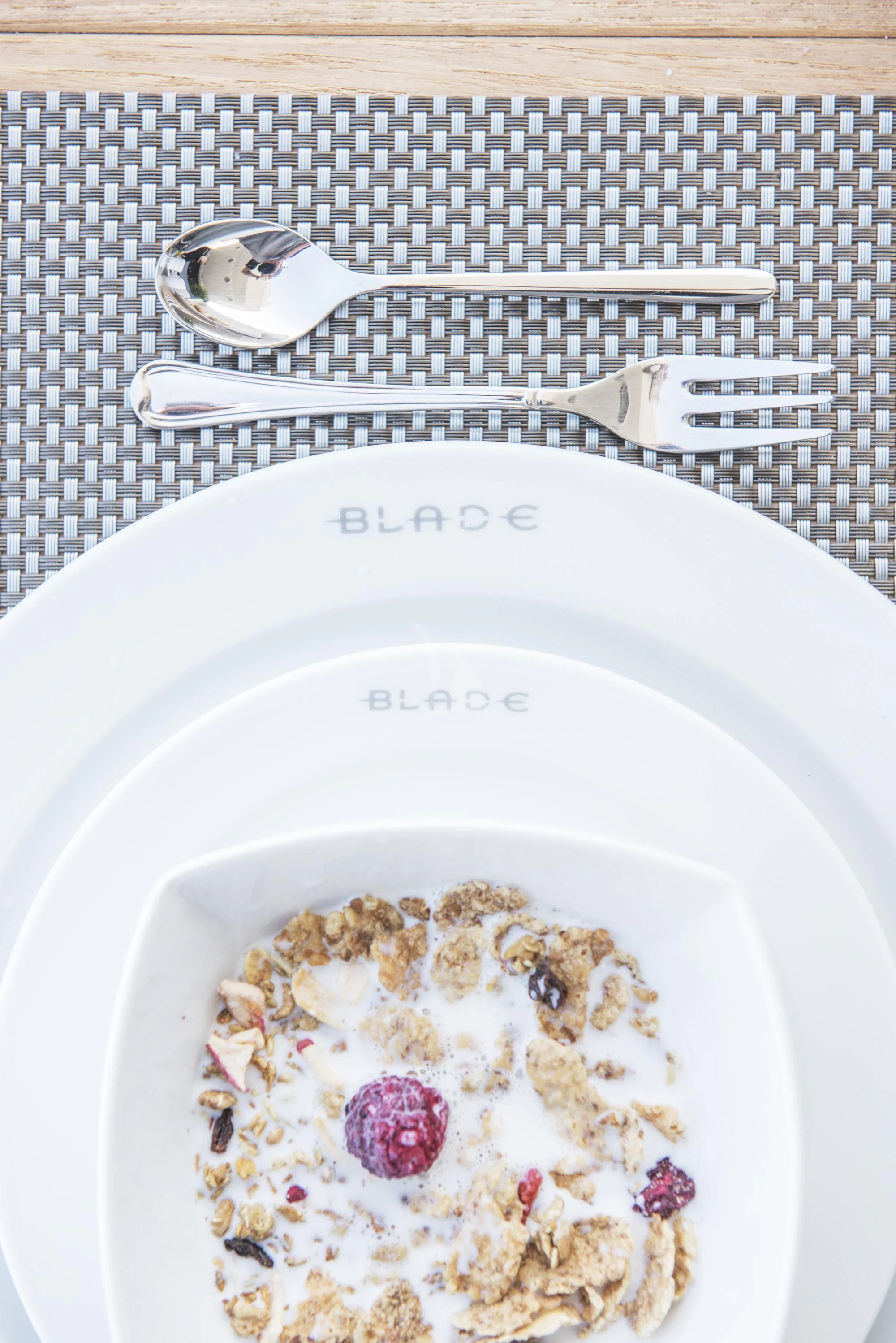 a bowl of cereal with milk and a spoon aboard BLADE 6 Yacht for Charter