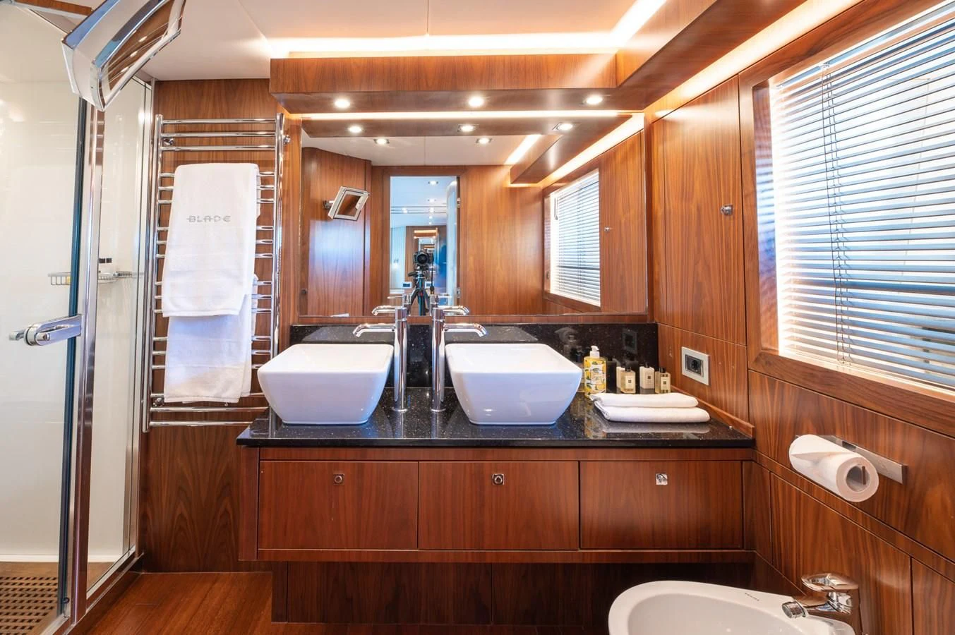 a bathroom with a sink and a mirror aboard BLADE 6 Yacht for Charter