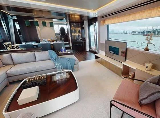 a living room with a large window aboard SUNSEEKER 88/508 Yacht for Sale
