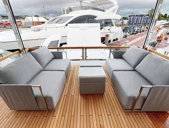 a room with a couch and a table with chairs on it aboard SUNSEEKER 88/508 Yacht for Sale