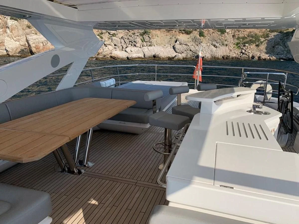 a deck with a railing and a railing with a body of water in the background aboard SUNSEEKER 86 Yacht for Sale