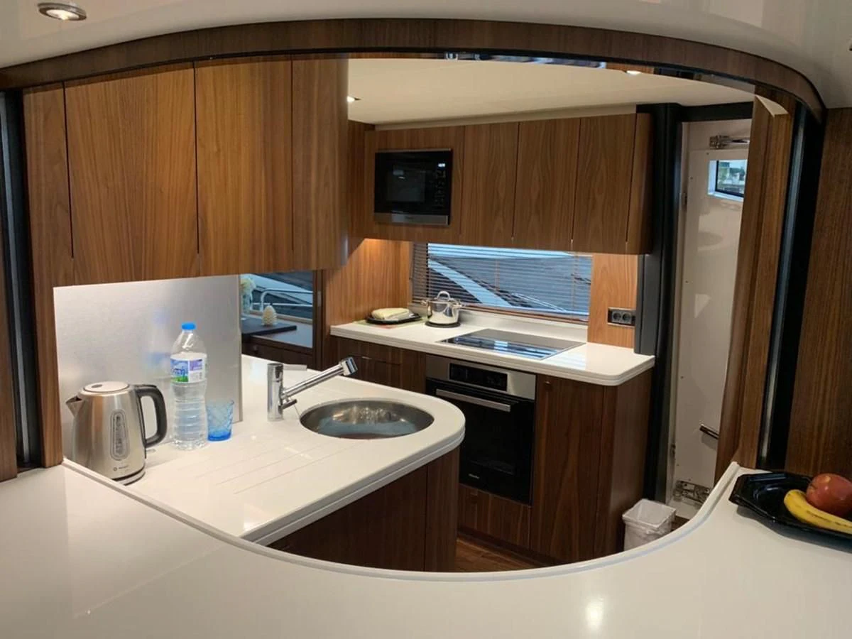 a kitchen with a sink and microwave aboard SUNSEEKER 86 Yacht for Sale