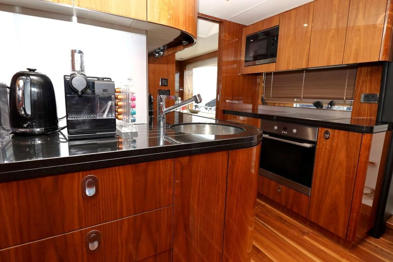 a kitchen with wooden cabinets aboard SUNSEEKER 86 Yacht for Sale