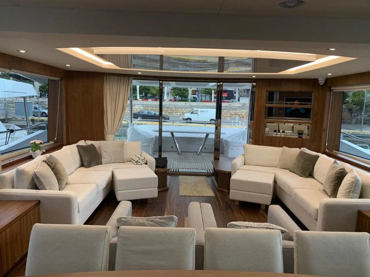 a living room with a large window aboard SUNSEEKER 86 Yacht for Sale