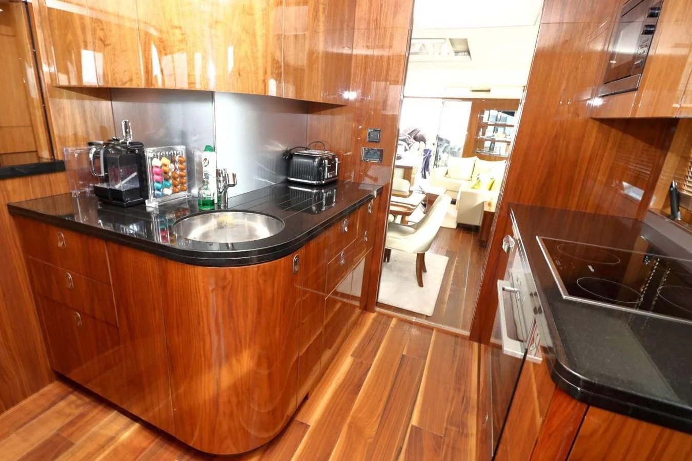 a kitchen with wooden cabinets aboard SUNSEEKER 86 Yacht for Sale