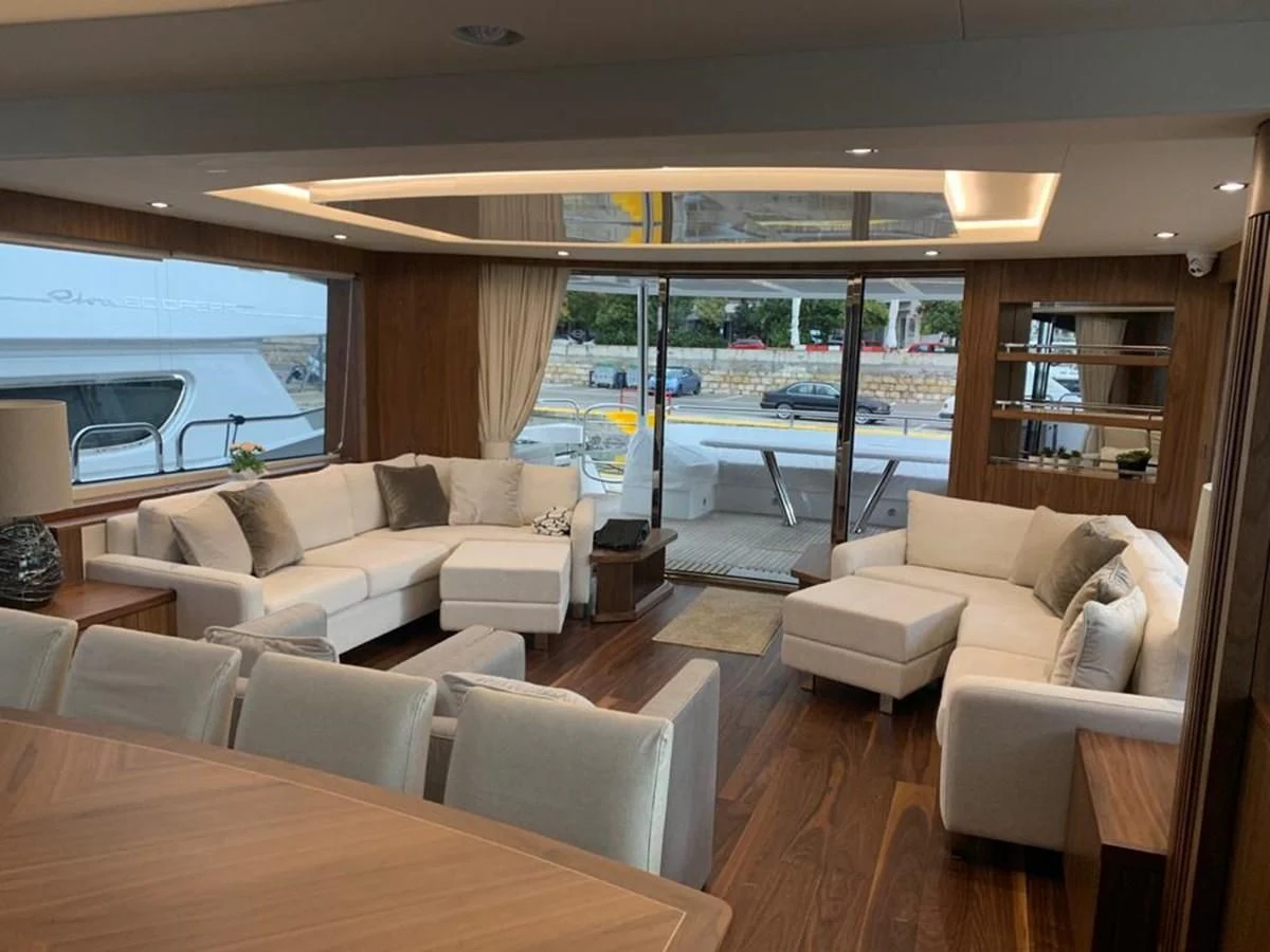 a living room with a large window aboard SUNSEEKER 86 Yacht for Sale