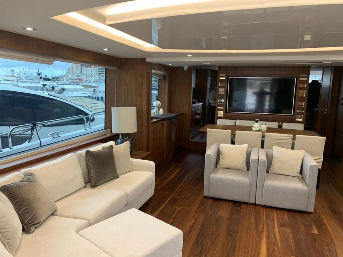 a living room with a large screen aboard SUNSEEKER 86 Yacht for Sale