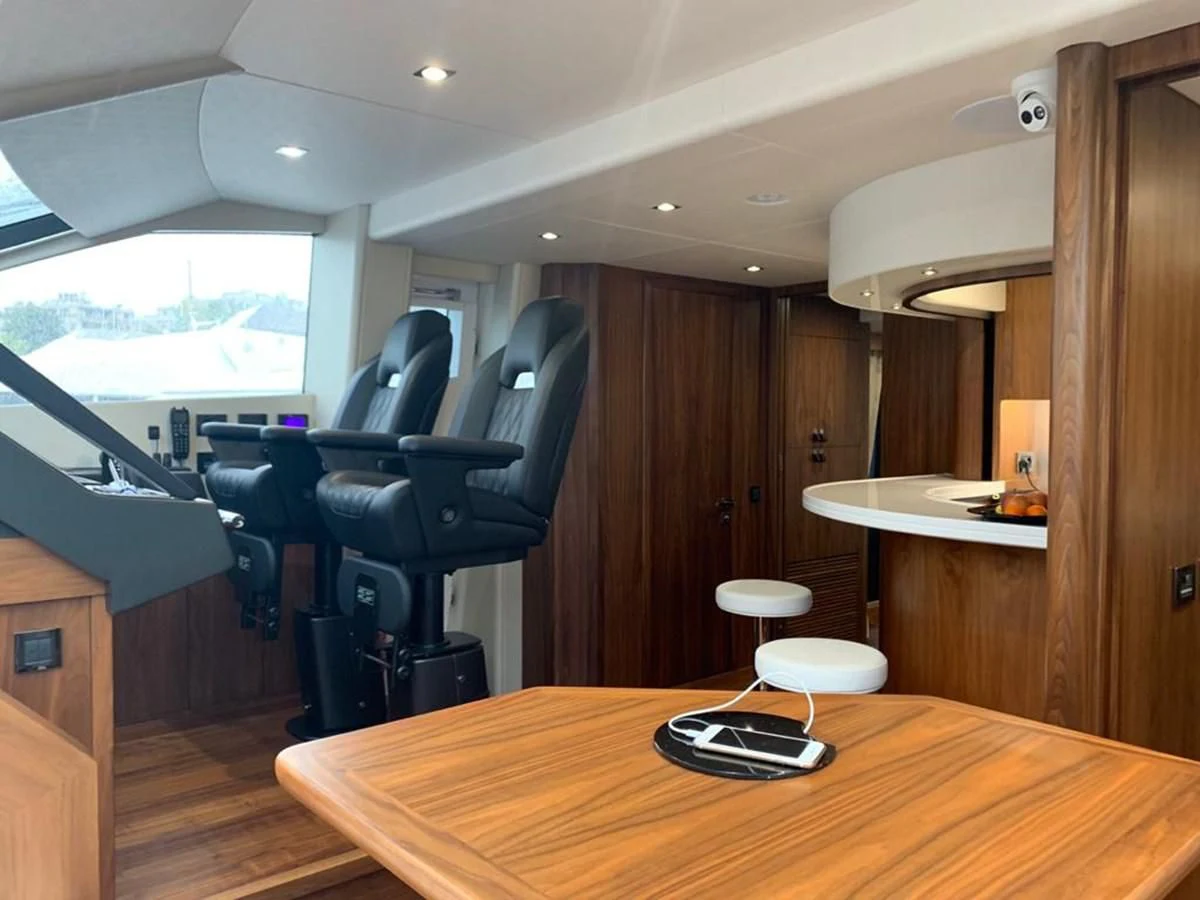 a room with a table and chairs aboard SUNSEEKER 86 Yacht for Sale