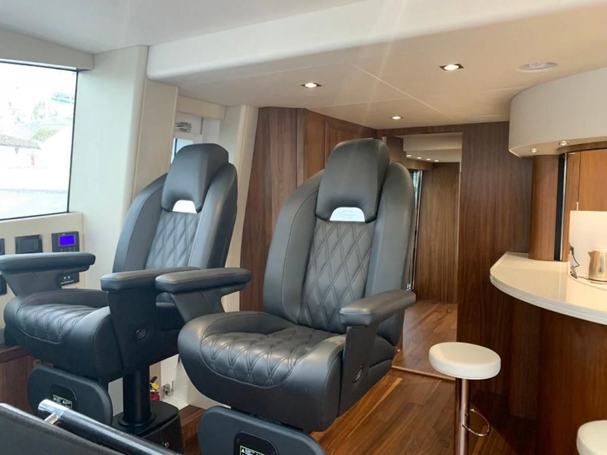 a room with chairs and a table aboard SUNSEEKER 86 Yacht for Sale