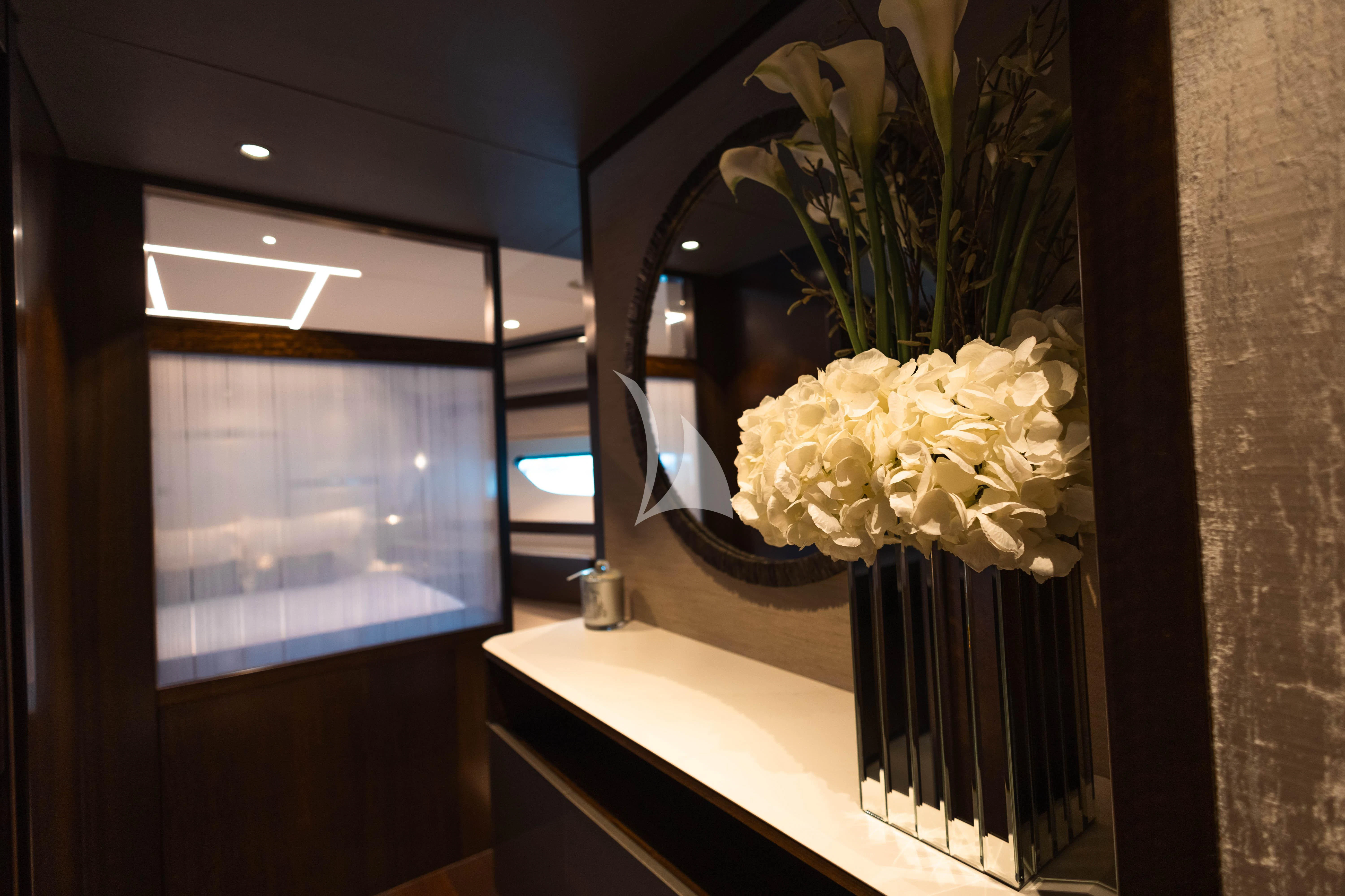 a vase of white flowers on a table aboard MOONLIGHT Yacht for Sale