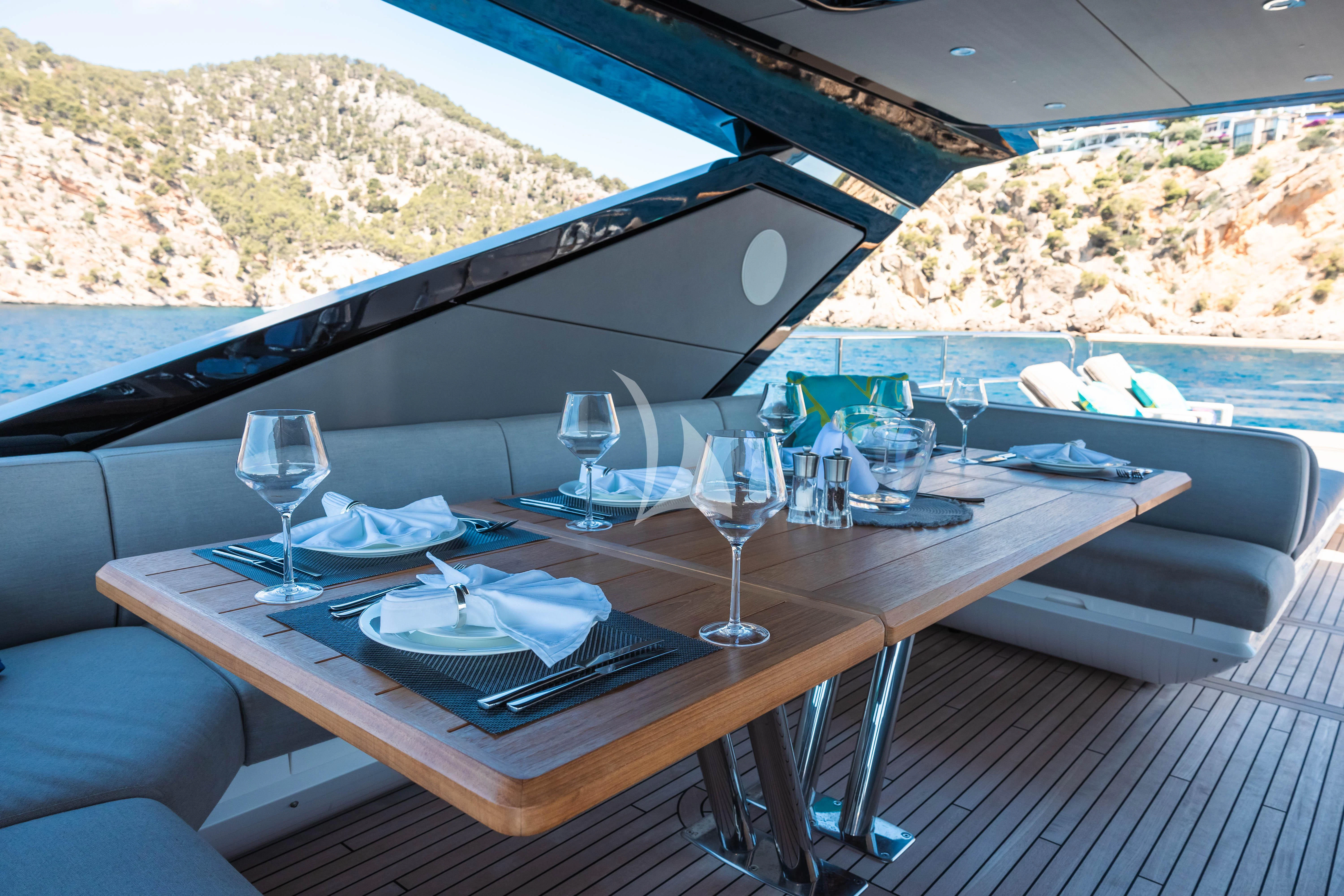 a table with plates and glasses on it aboard MOONLIGHT Yacht for Sale
