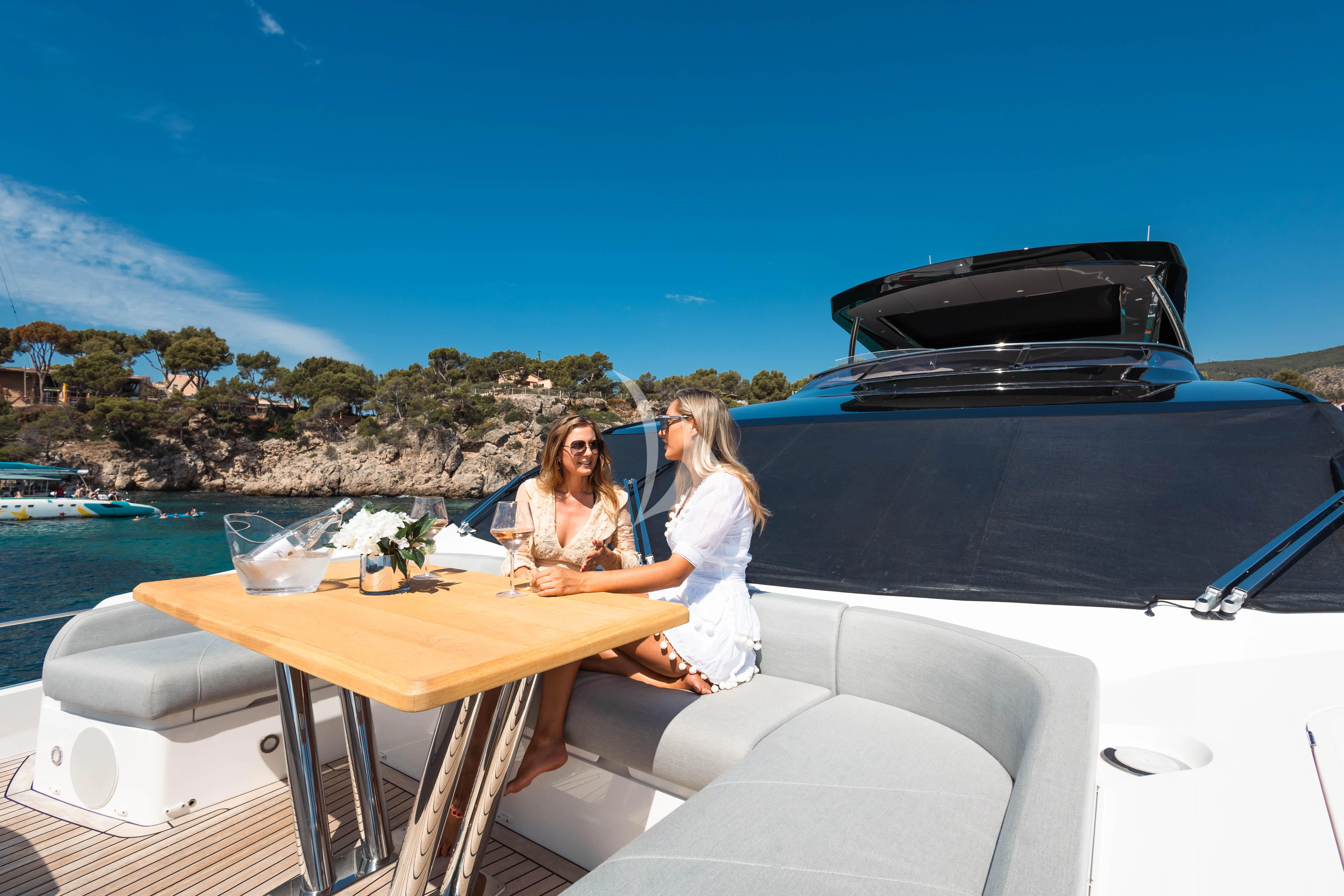 a couple of women sitting on a boat aboard MOONLIGHT Yacht for Sale