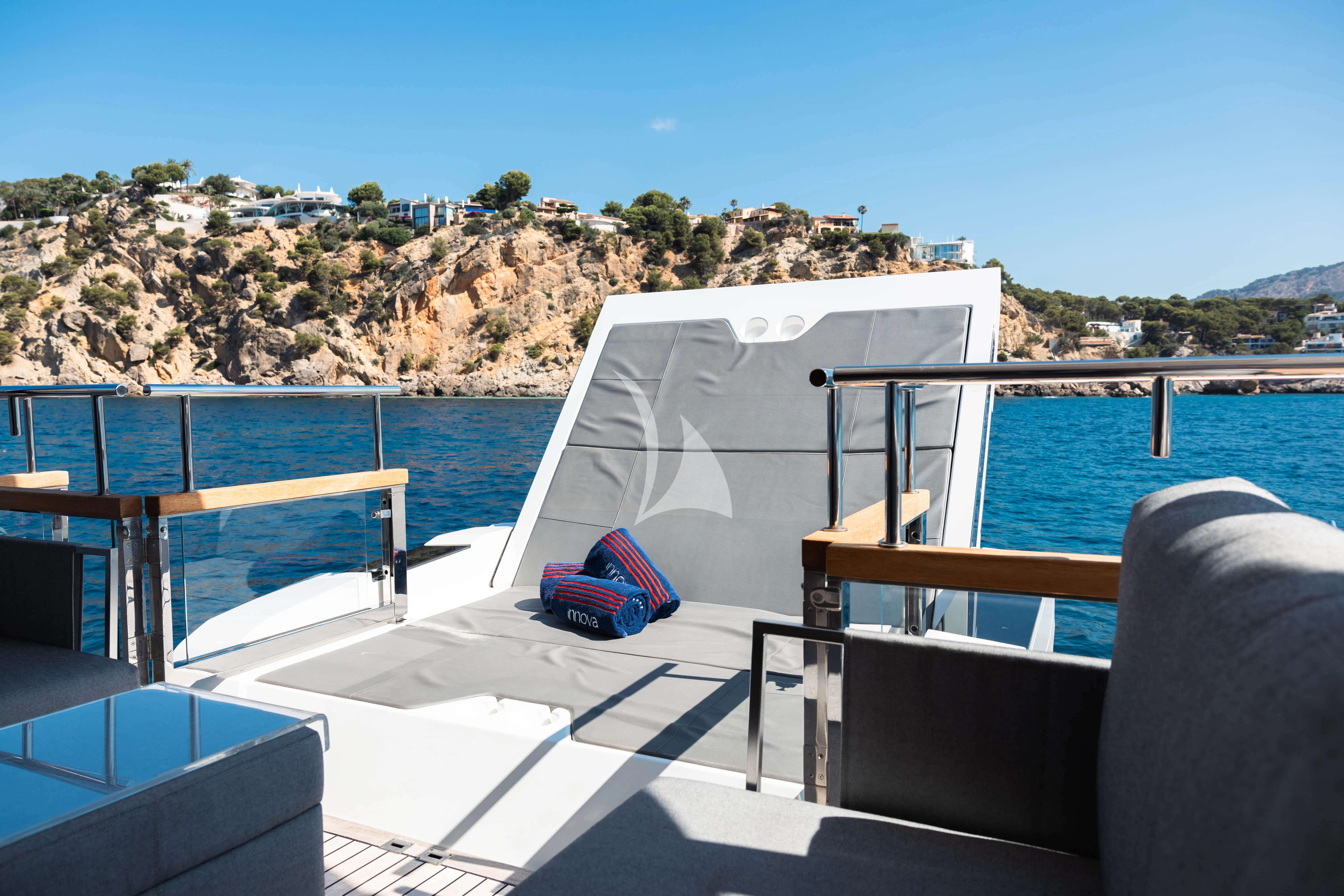 a deck with a blue towel on it and a backpack on it aboard MOONLIGHT Yacht for Sale