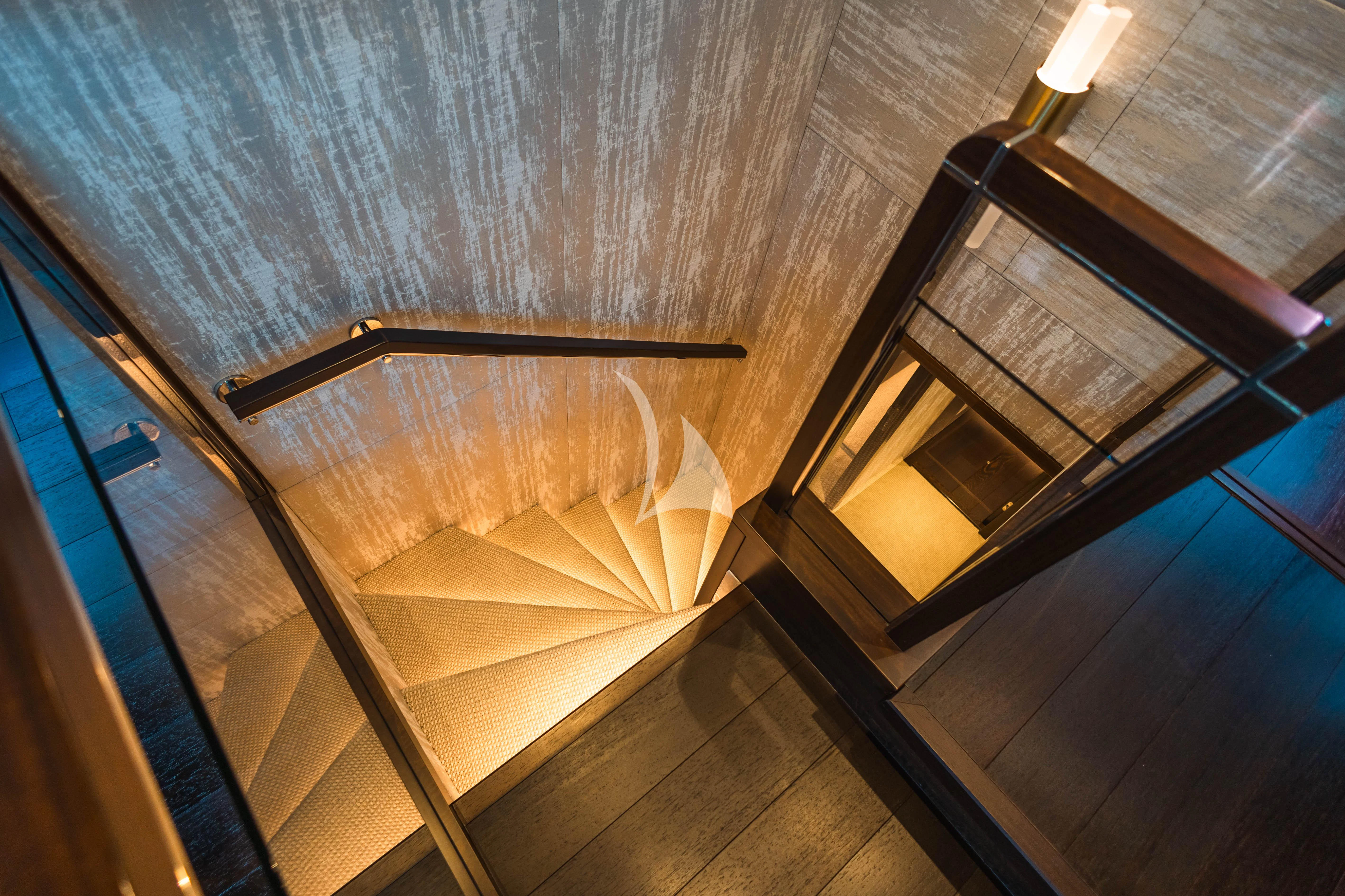 a room with wooden stairs aboard MOONLIGHT Yacht for Sale